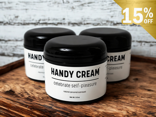 Three jars of Handy Cream on a wooden surface with a promotional label.