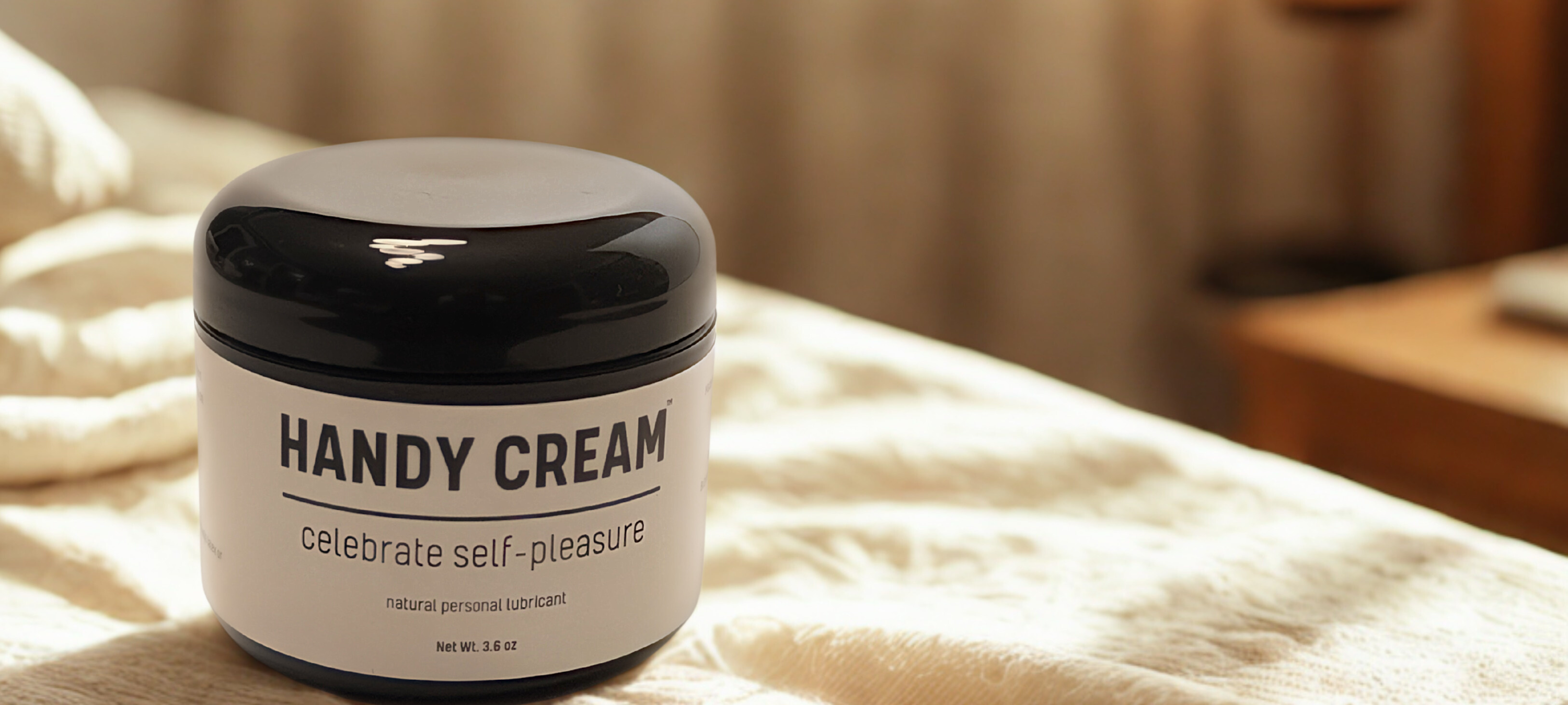 Handy Cream men’s moisturizer on bed with minimalist decor